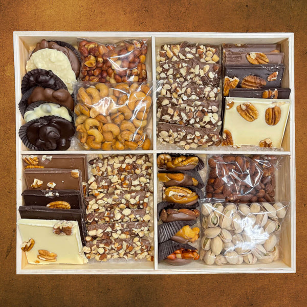Wooden tray divided into 4 sections with 4 bags of different nuts, buttercrunch, chocolate pecan bark, chocolate caramel nut clusters, and chocolate nut clusters.