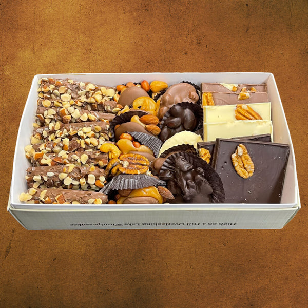 Kellerhaus box filled with 8 butter crunch, 6 chocolate caramel nut clusters 6 chocolate nut clusters, and 6 pieces of bark.