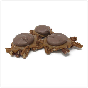 Three milk chocolate caramel pecan clusters.