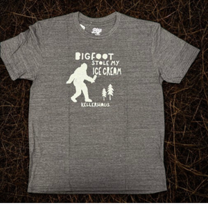 Triblend black short sleeve t-shirt with a bigfoot silhouette and trees. Words on shirt say Bigfood stole my ice cream Kellerhaus