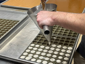 Dispensing creams into molds