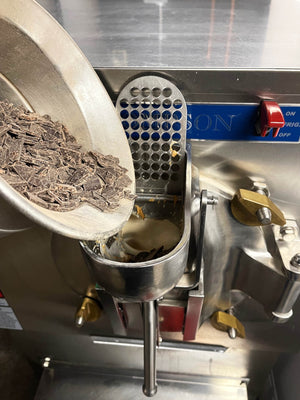 Pouring chocolate chunks into the ice cream machine