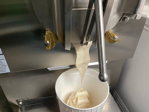 Ice cream pouring out of the ice cream machine.