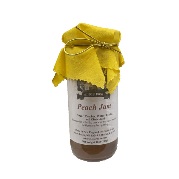 Jar of peach jam with gold elastic bow and yellow cloth around lid