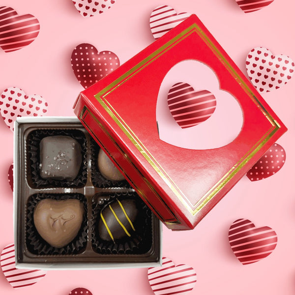 Four piece assorted chocolates red box with heart shaped window to see chocolates.