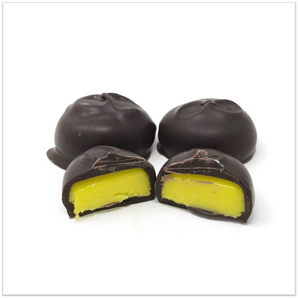 Dark Chocolate banana cream cut in half in front of two other banana creams